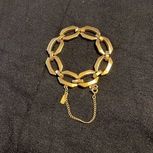 Monet gold tone link bracelet with safety chain